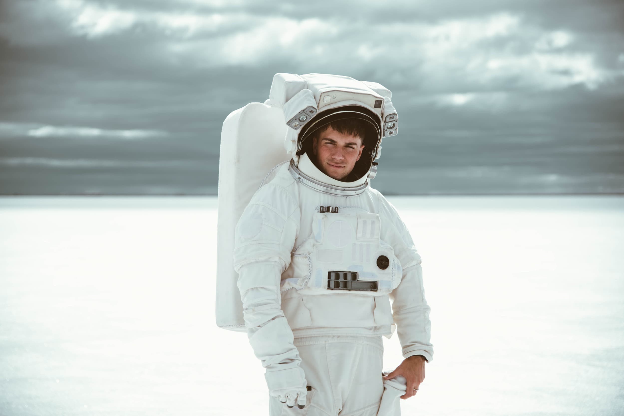 Astronaut in a white suit against a pale sky